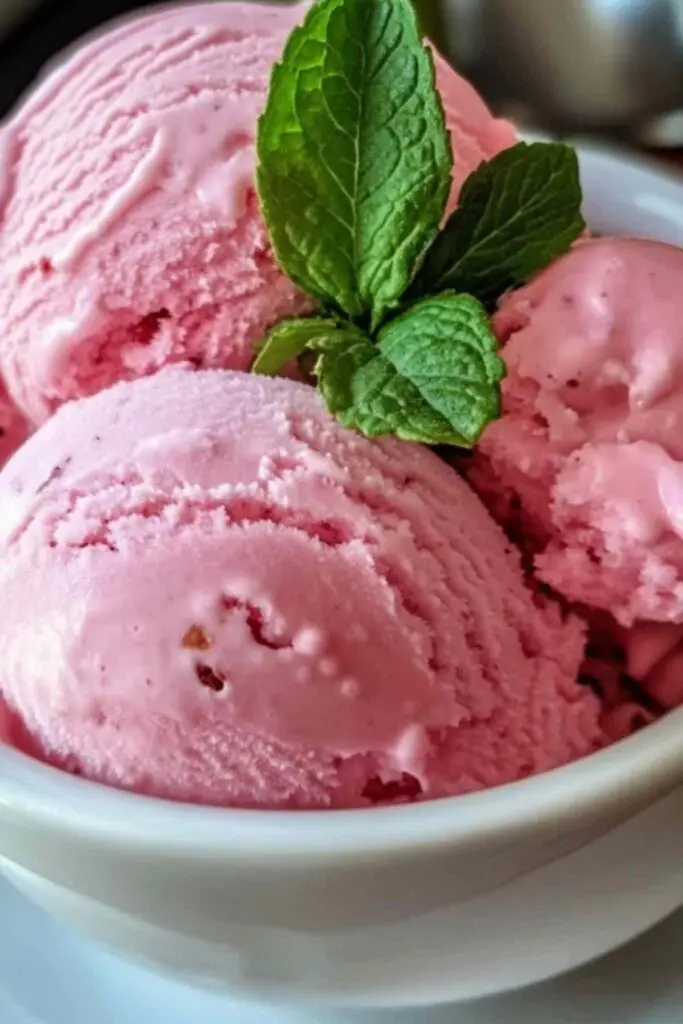 Coupe de glace à la rhubarbe maison servie avec des morceaux de rhubarbe confite