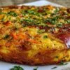 Moelleux aux carottes, courgettes et jambon cru, doré et cuit à la perfection dans un moule à manquer.