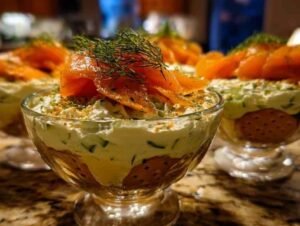 Tiramisu salé aux courgettes et saumon fumé servi dans une verrine élégante avec un brin d'aneth.
